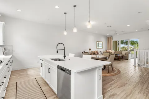 a large kitchen with stainless steel appliances kitchen island granite countertop a large center island attached withe living room