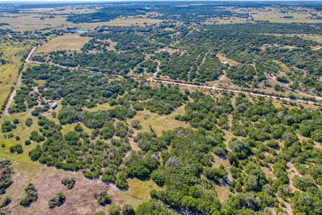 an aerial view of a houses with a yard