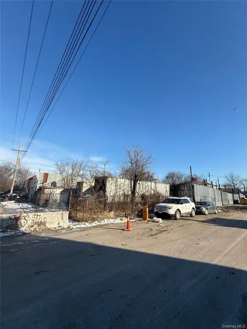 a view of large building with cars parked on the road