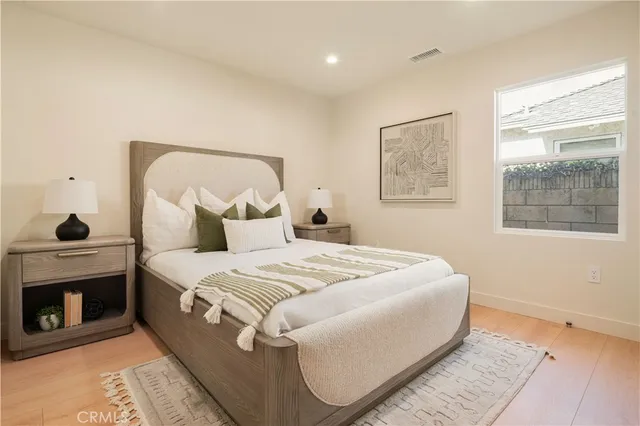 a bed sitting in a bedroom next to a window