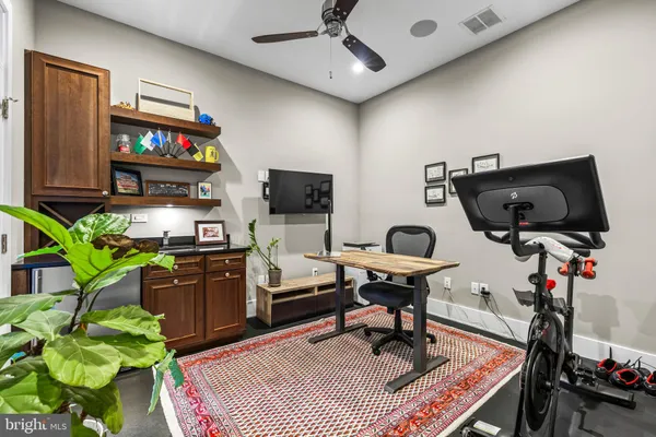 a living room with furniture a piano and a flat screen tv