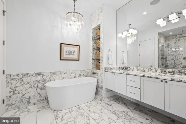 a bathroom with a bathtub sink and mirror