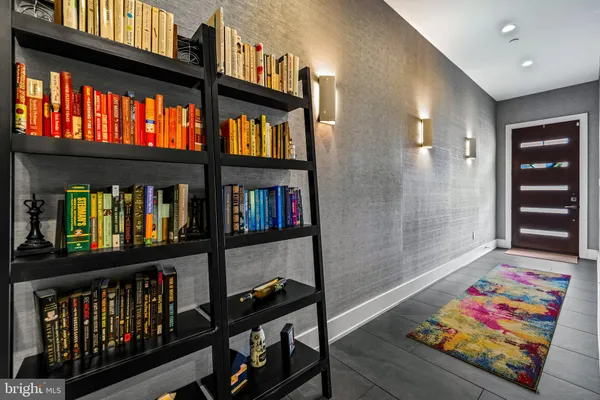 a living room with lots of furniture and a book shelf