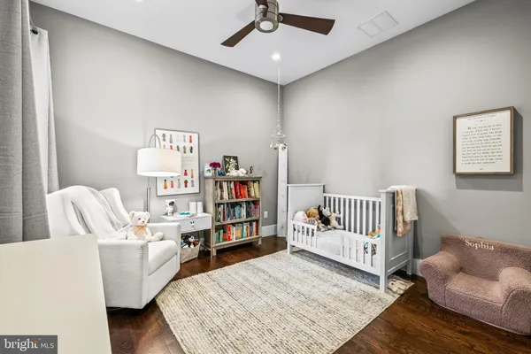 a living room with furniture and baby crib