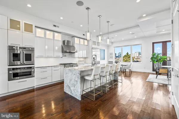 a large kitchen with lots of counter space a sink and appliances