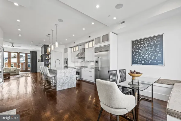 a dining room with furniture and wooden floor
