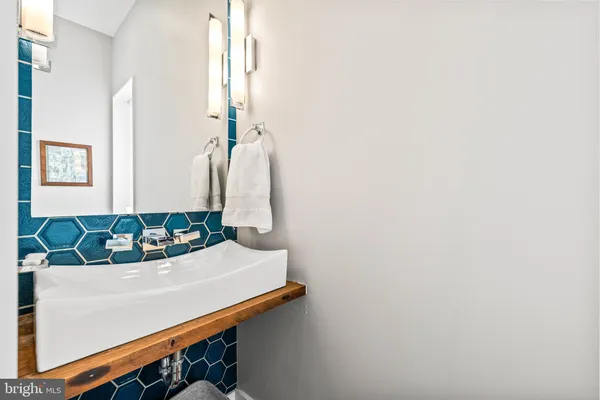 a living room with a couch and a potted plant