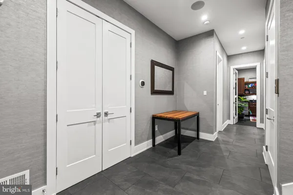 a hallway with furniture and a potted plant