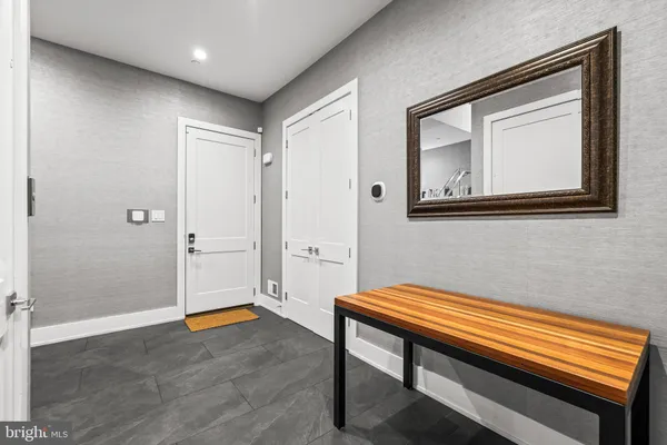 a hallway with a wooden floor and a bathroom