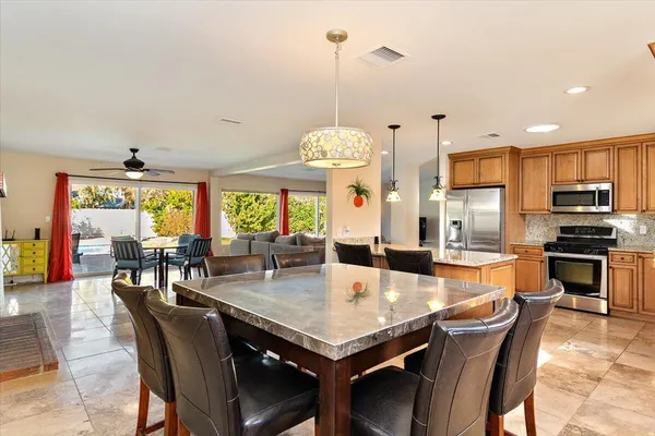 a dining table with chairs and window