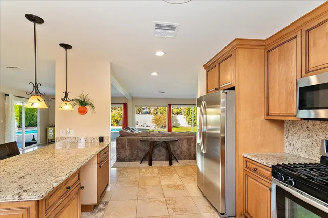 a kitchen with stainless steel appliances granite countertop a sink and stove
