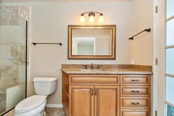a bathroom with a toilet a sink and a mirror