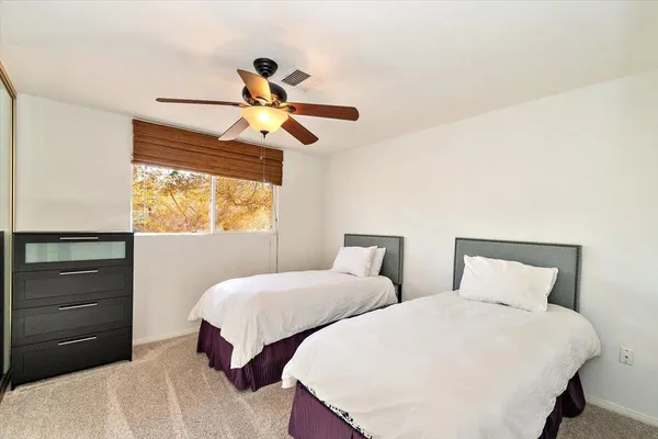 a bedroom with two beds and a window
