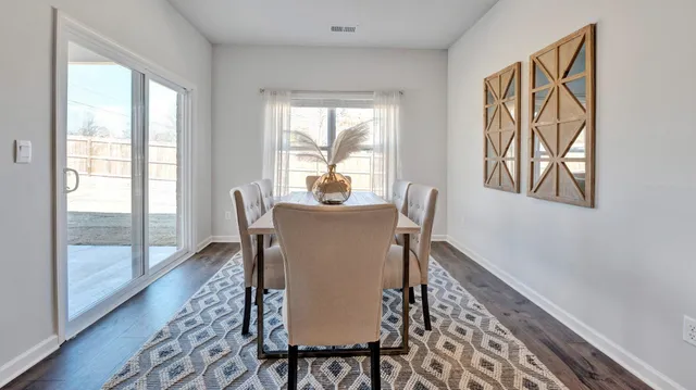 a dining room with furniture wooden floor and a rug