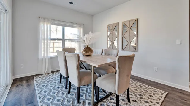a view of a dining room with furniture wooden floor and a carpet