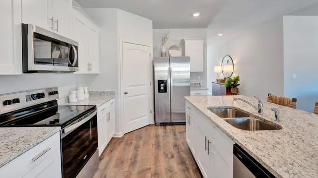a kitchen with sink refrigerator and window