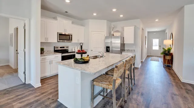 a kitchen with granite countertop a sink and a stove top oven