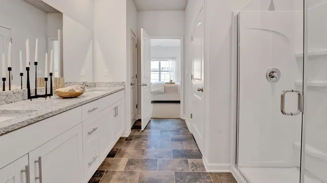 a bathroom with a granite countertop mirror and a sink