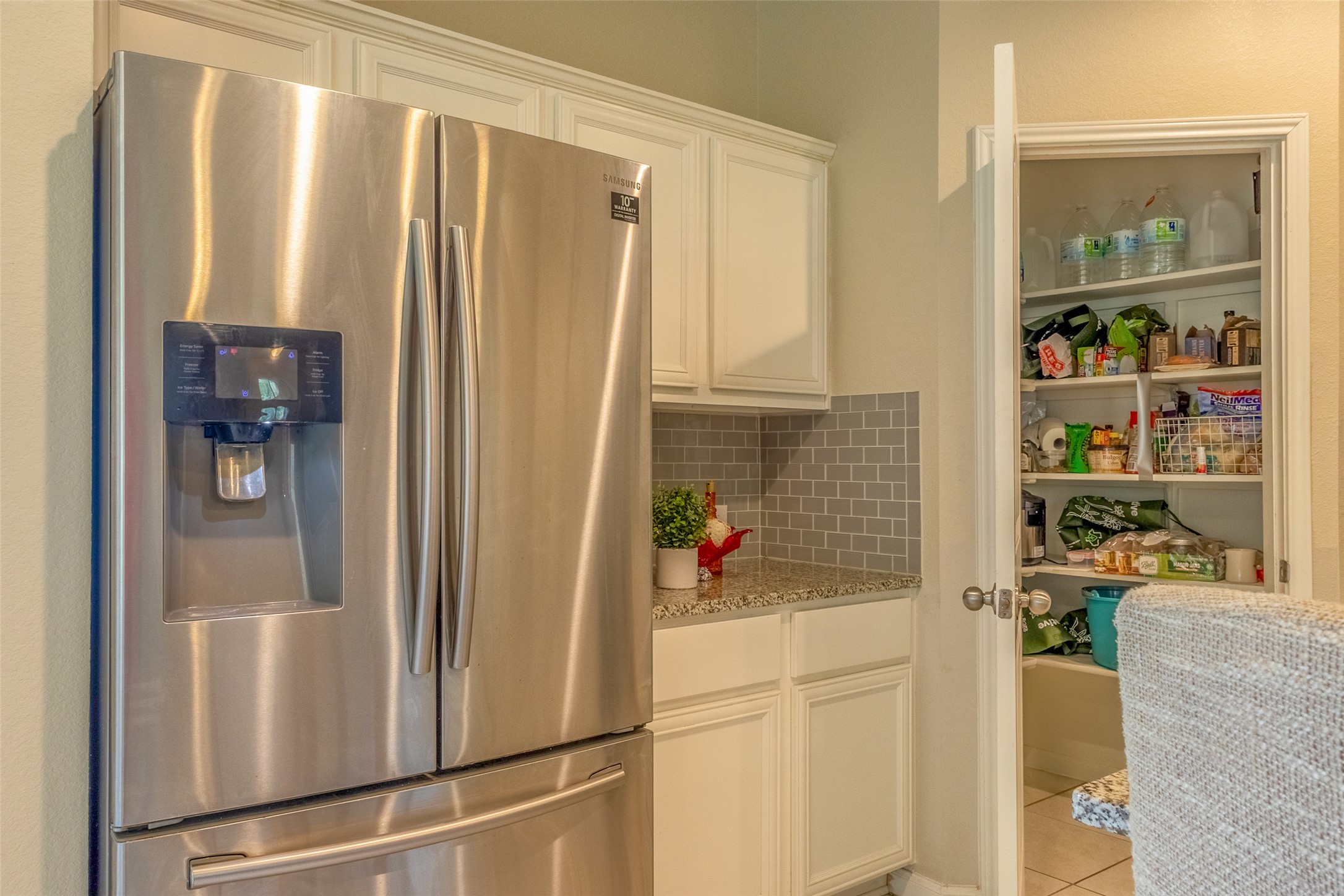 7225 Ranchito Drive Austin, TX 78744 - Photo 13 of 39 A well-appointed kitchen features ample pantry storage, sleek stainless steel appliances, and elegant granite counters.