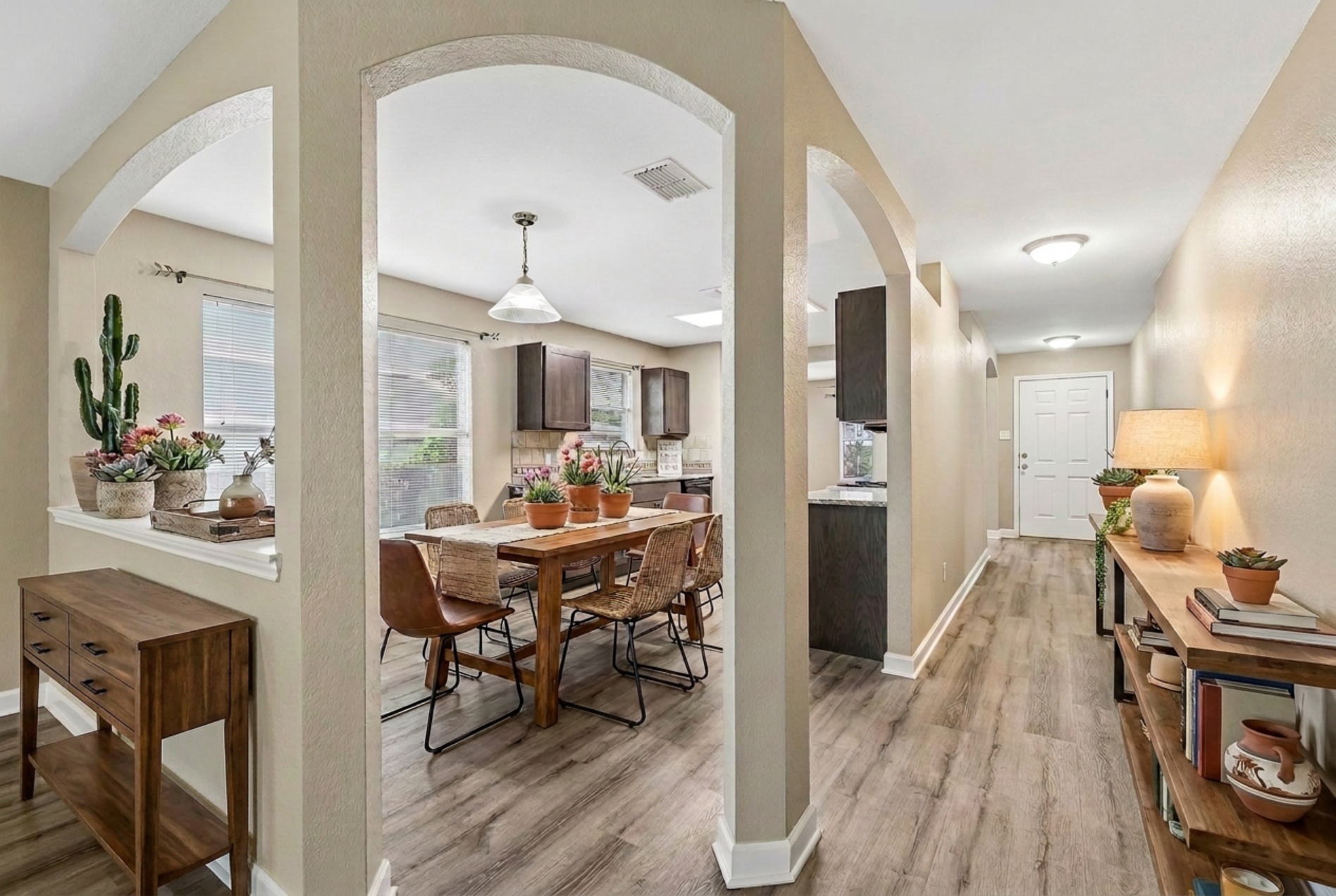 152 Grant Way Kyle, TX 78640 - Photo 4 of 39 a view of a dining room with furniture and wooden floor