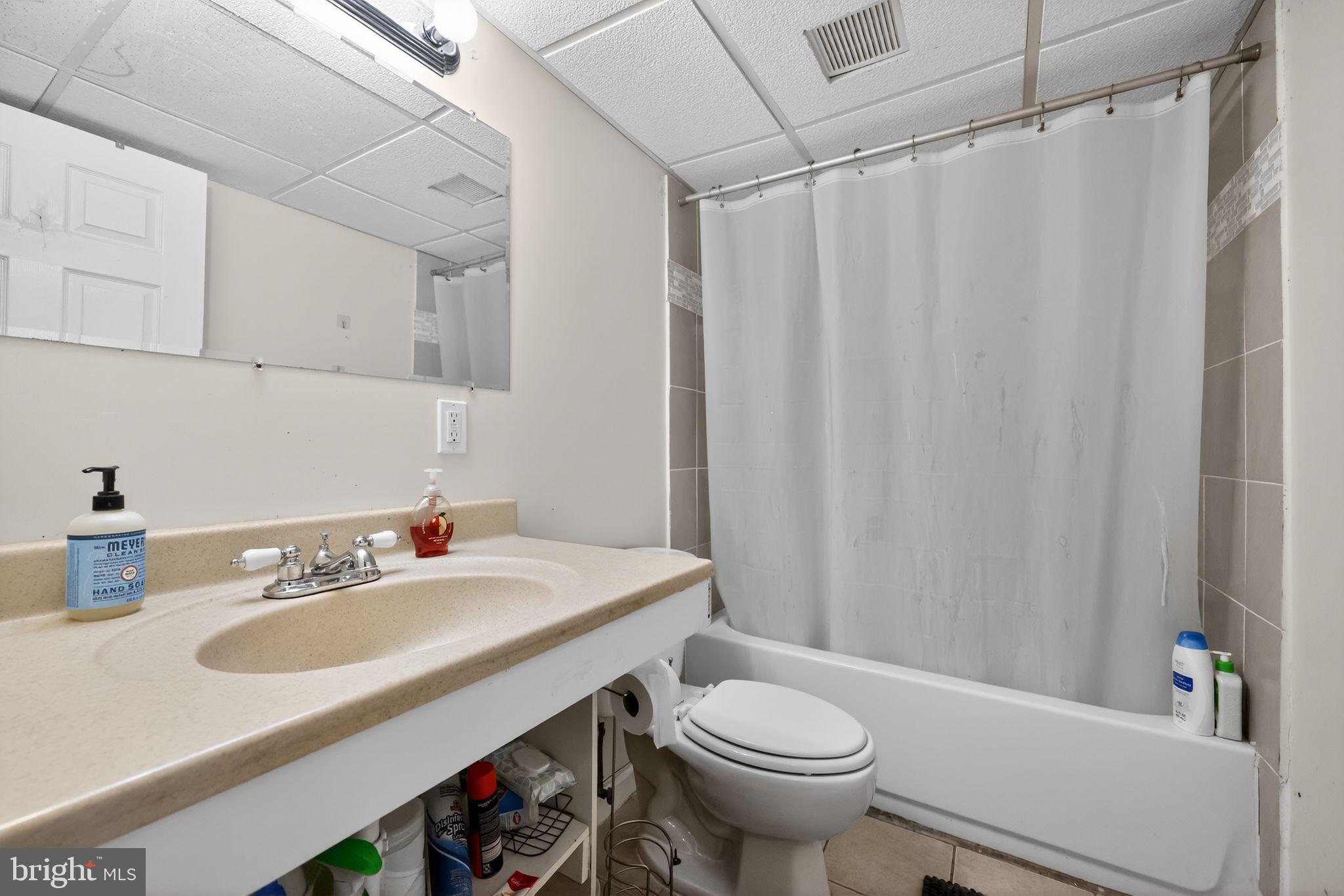 438 Ewingville Road Ewing, NJ 08638 - Photo 38 of 43 a bathroom with a sink a toilet and shower curtain