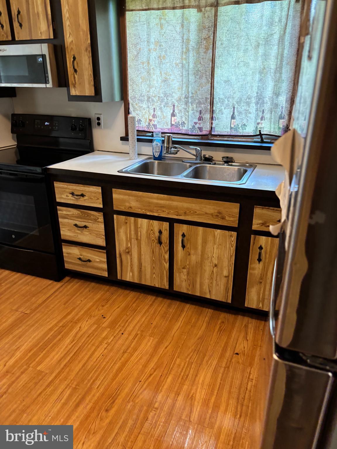 438 Ewingville Road Ewing, NJ 08638 - Photo 5 of 43 a view of a kitchen with a sink and wooden floor