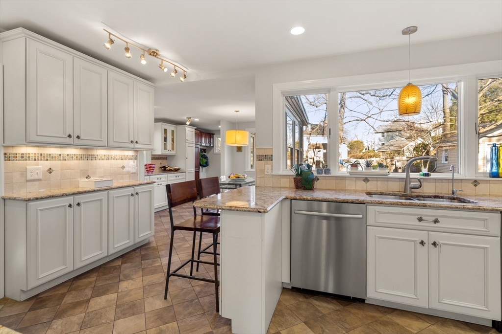 48 Stone Road Belmont, MA 02478 - Photo 15 of 41 a kitchen with white cabinets and sink