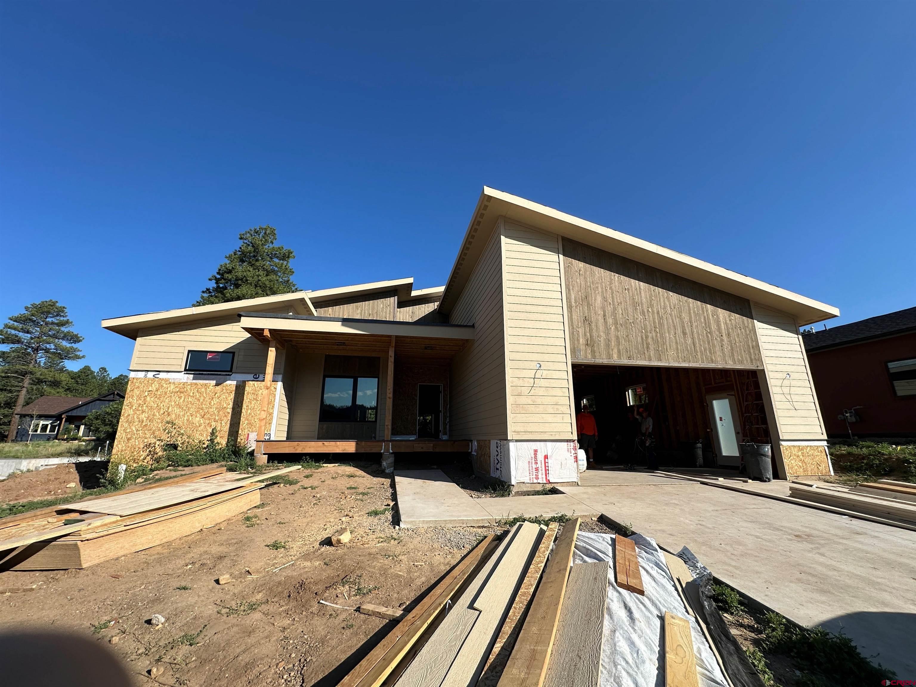 132 Edgemont Meadows Road Durango, CO 81301 - Photo 3 of 7 a view of a house with a barbeque and wooden stairs