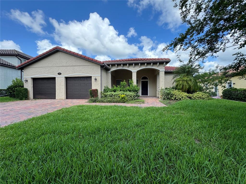 a front view of house with yard and green space