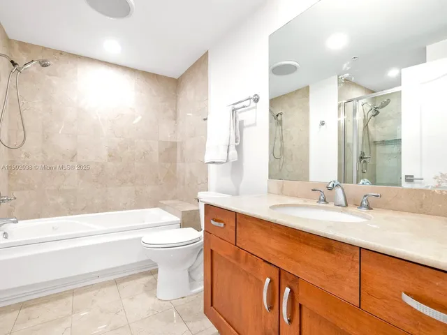 a bathroom with a shower and a bath tub