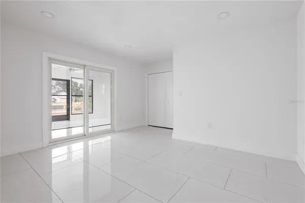 an empty room with windows and entrance