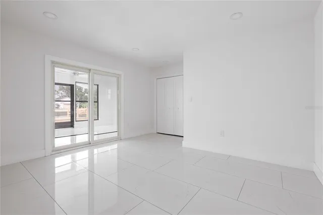 an empty room with windows and entrance