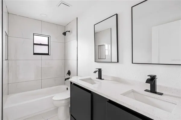 a view of a livingroom with wooden floor and a ceiling fan