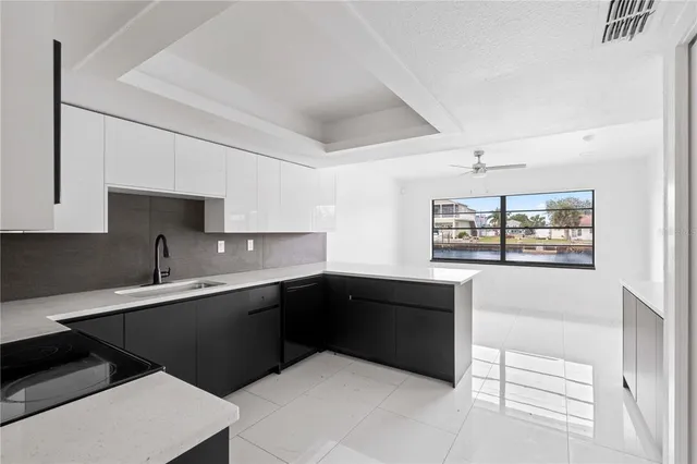 a kitchen with a sink and stove top oven