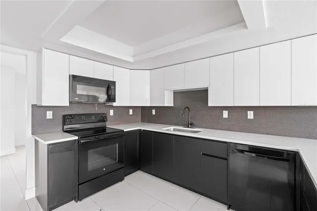 a kitchen with a sink and a refrigerator