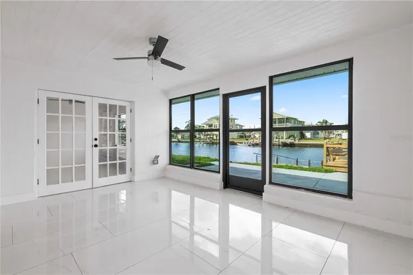 a front view of a house with a yard and potted plants