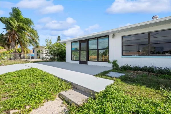 a view of a swimming pool with an outdoor seating and a garden