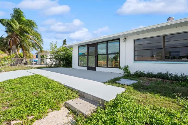 a view of a swimming pool with an outdoor seating and a garden