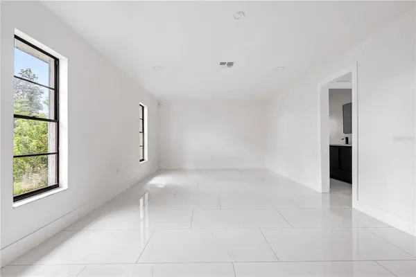 an empty room with windows and closet