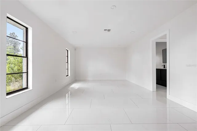 an empty room with windows and closet