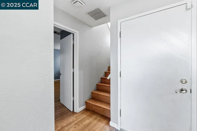 a view of entryway with stairs and wooden floor