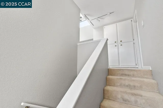 a view of staircase with white walls