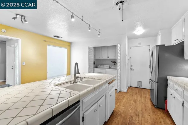 a spacious bathroom with a double vanity sink a mirror and a shower