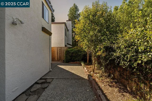 a view of a pathway of a house with a yard