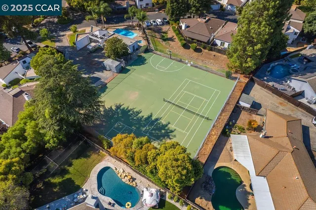 an aerial view of a house with a yard and lake view