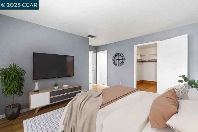 a bedroom with a bed and a flat screen tv