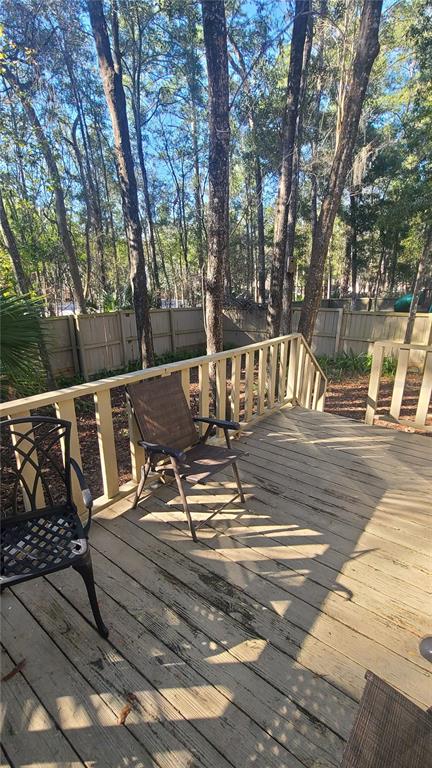 5324 Southwest 88 Court Gainesville, FL 32608 - Photo 21 of 21 a view of a patio with a table and chairs and wooden fence