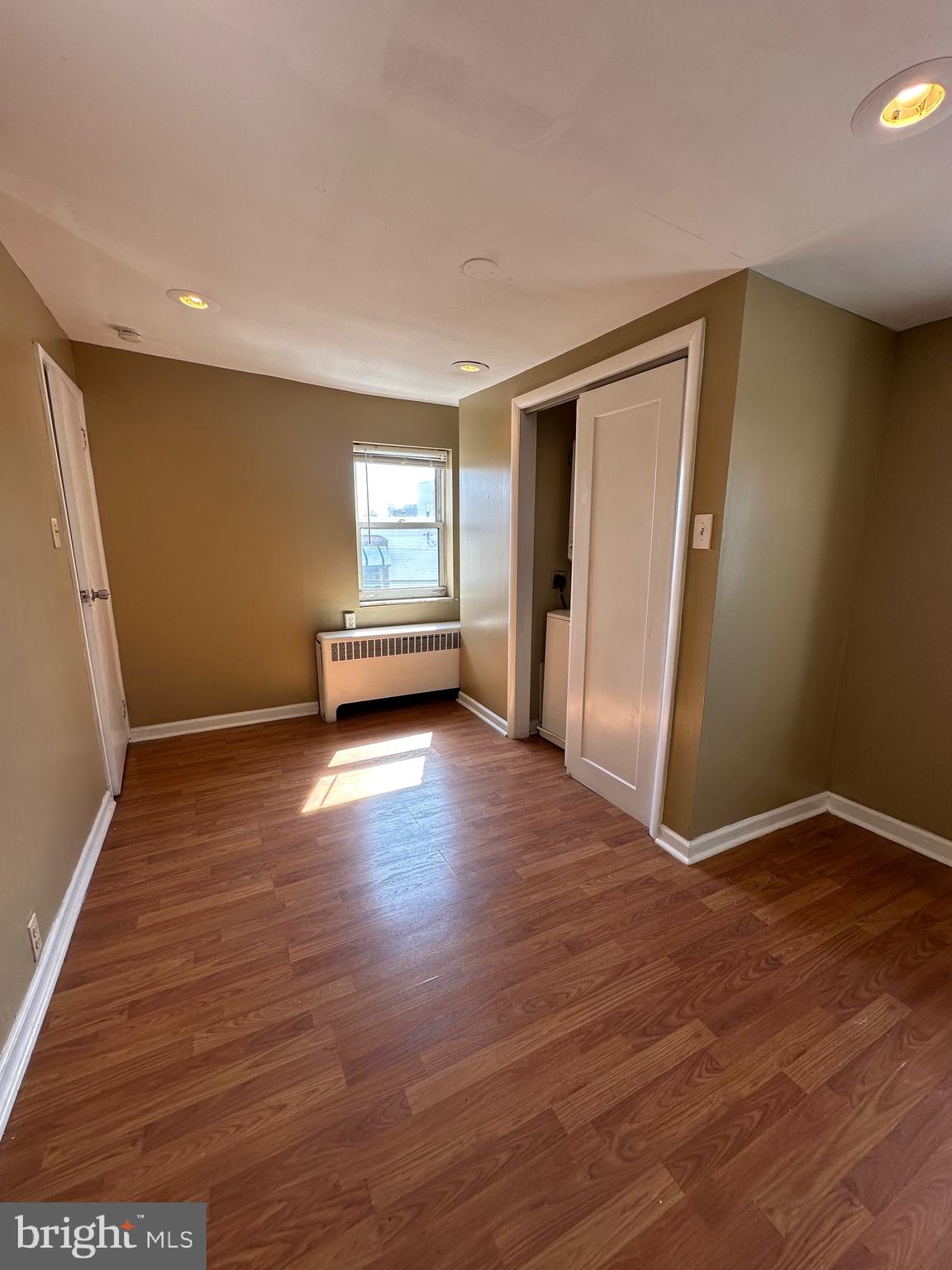 1846 South 12th Street, Unit 2 Philadelphia, PA 19148 - Photo 12 of 18 an empty room with wooden floor and windows