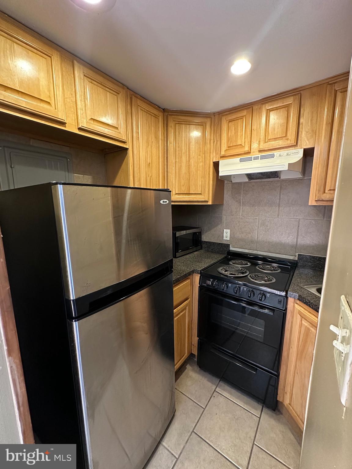 1846 South 12th Street, Unit 2 Philadelphia, PA 19148 - Photo 2 of 18 a kitchen with stainless steel appliances granite countertop a refrigerator stove a sink and dishwasher