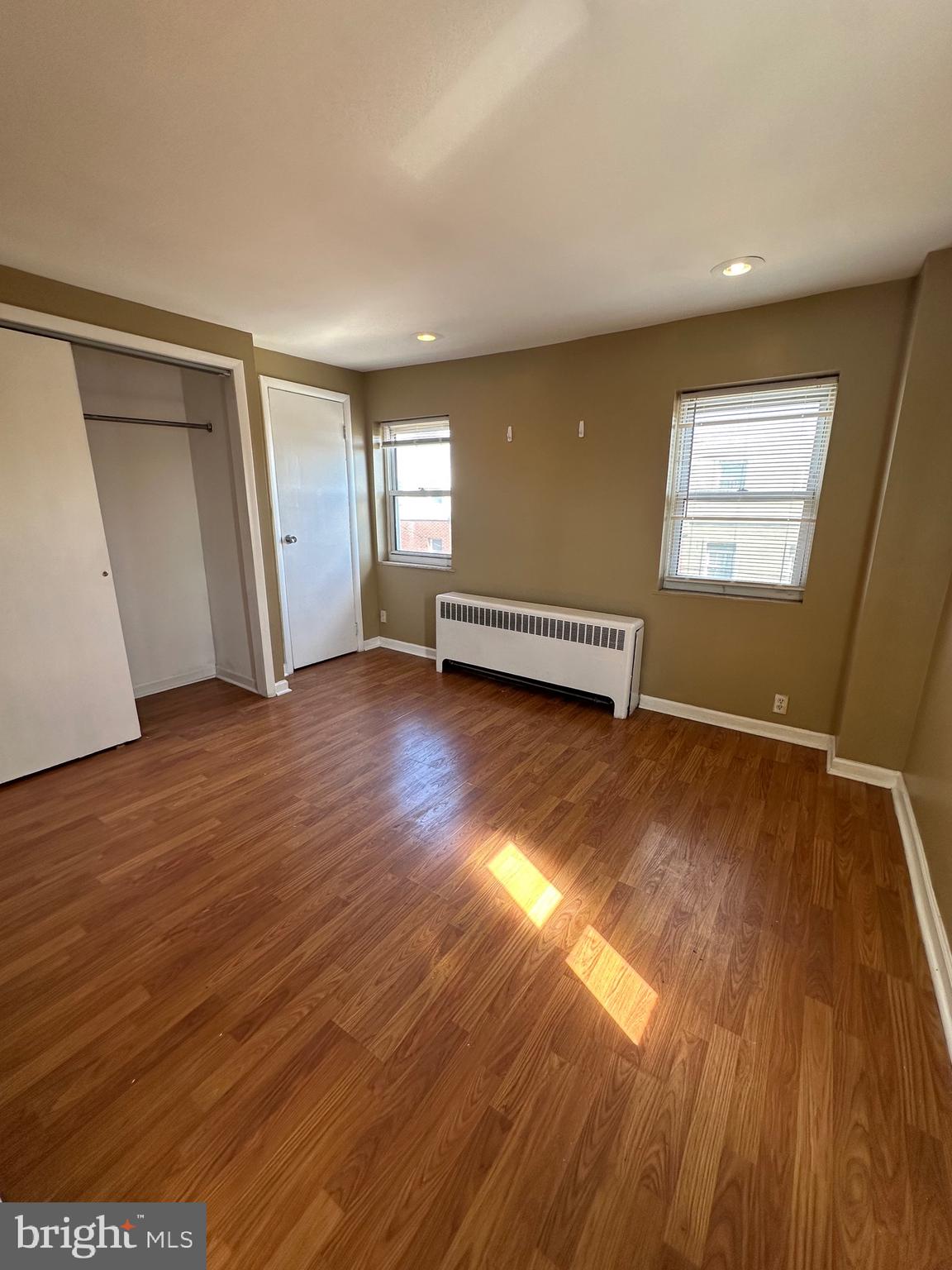 1846 South 12th Street, Unit 2 Philadelphia, PA 19148 - Photo 3 of 18 an empty room with wooden floor and windows